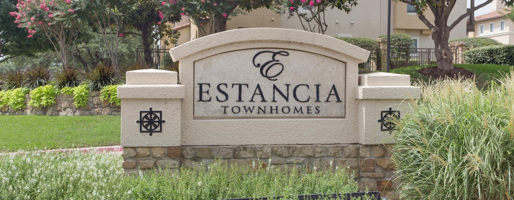 a stone sign in a garden