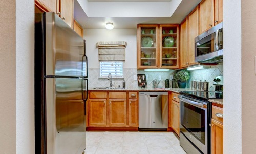 a kitchen with wooden cabinets