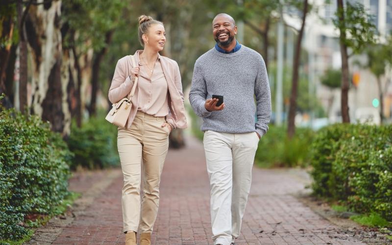 The essence of exceptional living a man and a woman walking on a sidewalk