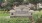 a stone sign in a garden
