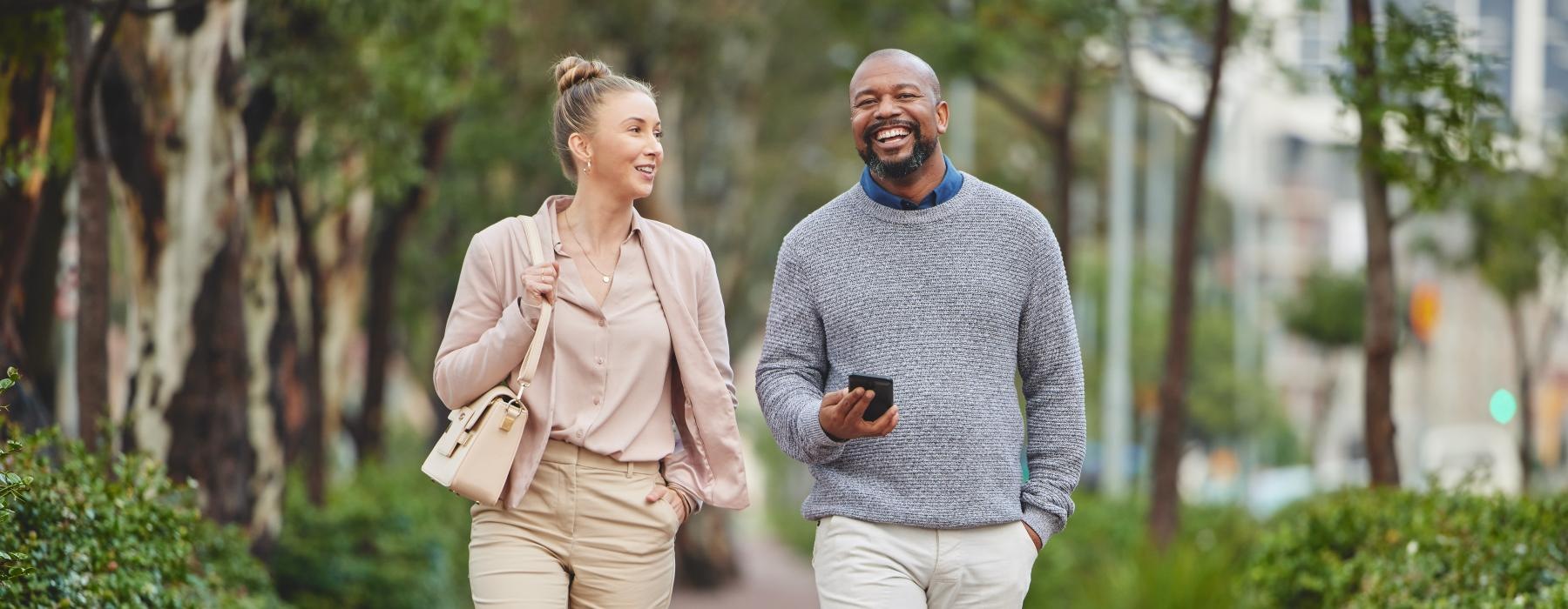 a man and a woman walking on a sidewalk