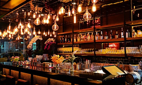 a bar with many bottles of alcohol